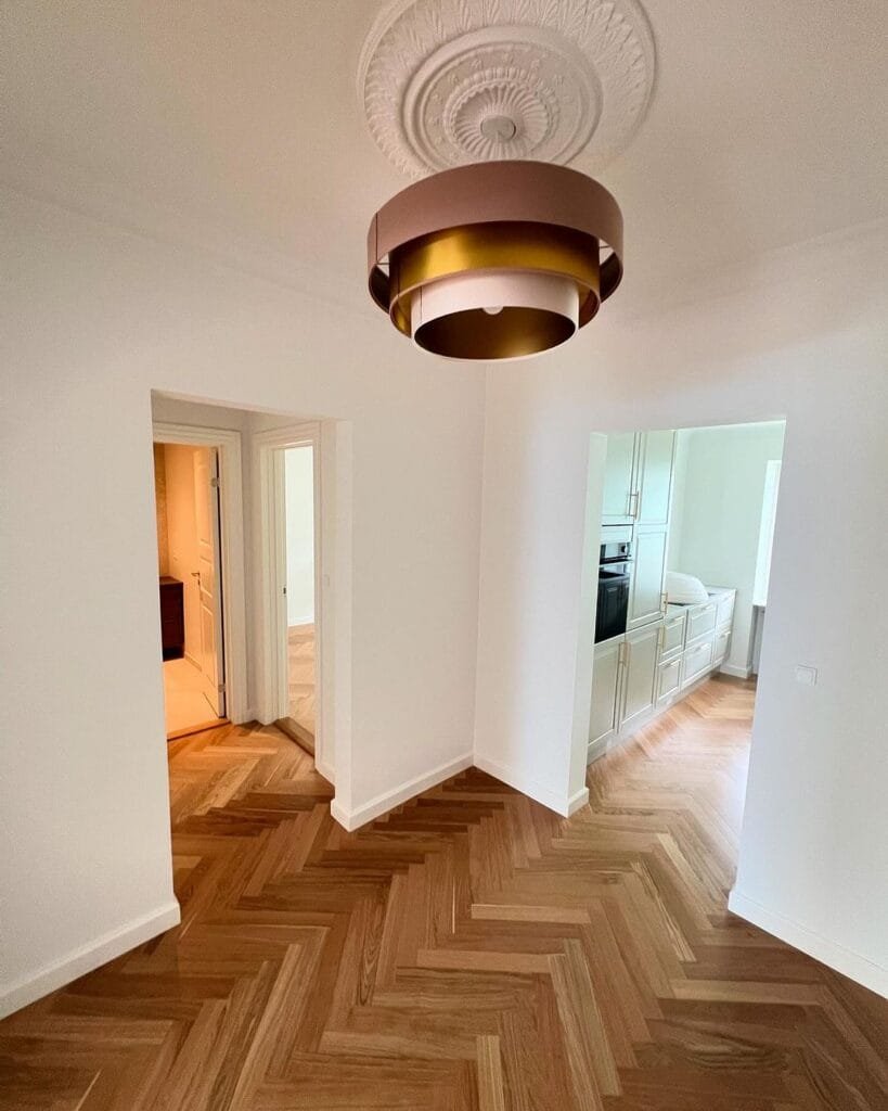 Moderne stue med parketgulv og dekorativt loft.